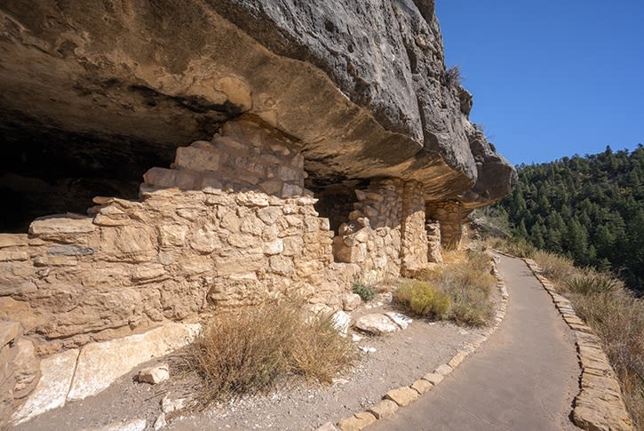 A curved walking path along an ancient dwelling.
